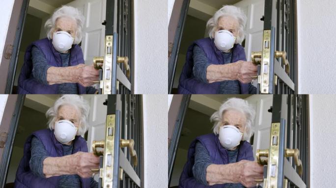 老年高加索妇女谨慎地缓慢打开前门感到不确定，并戴着n95防护口罩，以防止冠状病毒传染性非典型肺炎传播