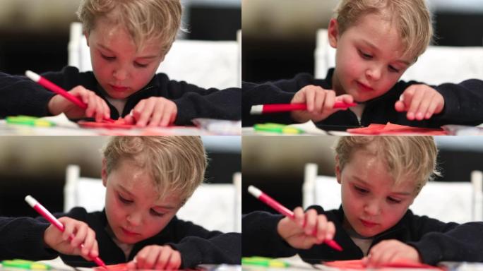 艺术幼儿用红色彩色笔在纸上绘画
