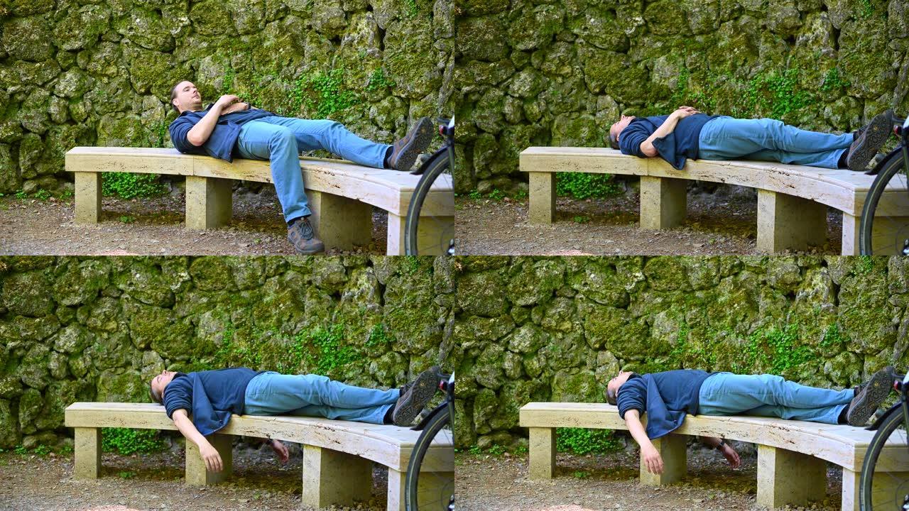 一个人躺在石凳上，背景是旧石墙，放松身心