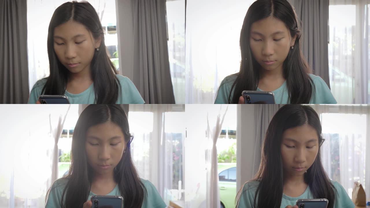 亚洲女孩在家中使用智能手机，生活方式和居家理念。