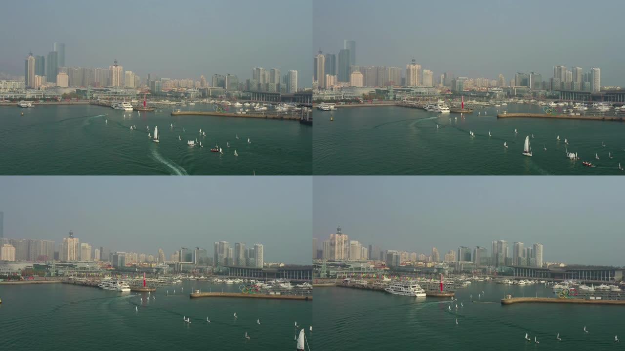 阳光明媚的夜晚青岛市著名奥运帆船交通湾码头空中全景4k中国