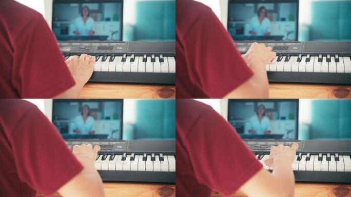 一个年轻的学生在网上看音乐课，在家学习。