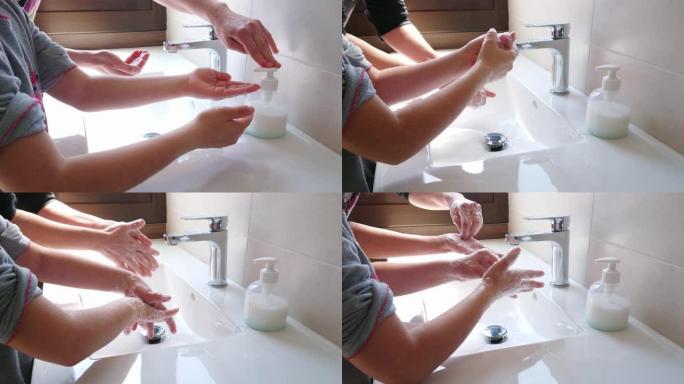 母亲教导并帮助女儿用肥皂洗手以防止冠状病毒感染