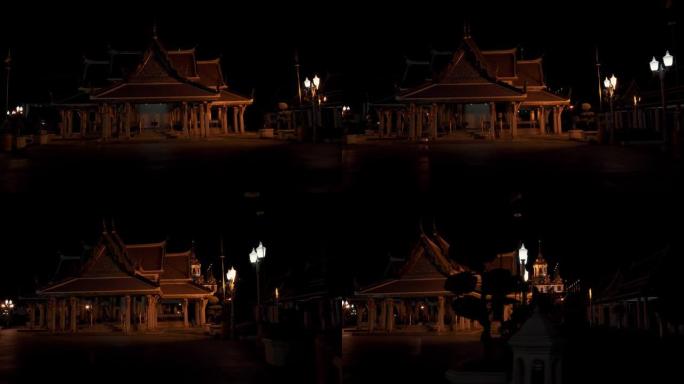 从泰国曼谷的一辆汽车上晚上拍摄的寺庙的左向右拍。曼谷是泰国首都
