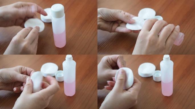 女人的手拿一个带指甲油去除剂的棉垫，从指甲上擦掉旧的指甲油