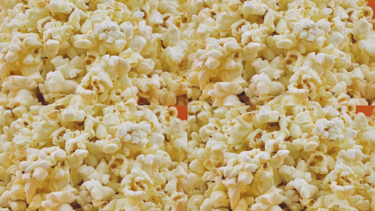 爆米花旋转特写，通风爆米花小吃在电影院，娱乐场所。爆米花背景。爆米花旋转缓慢。