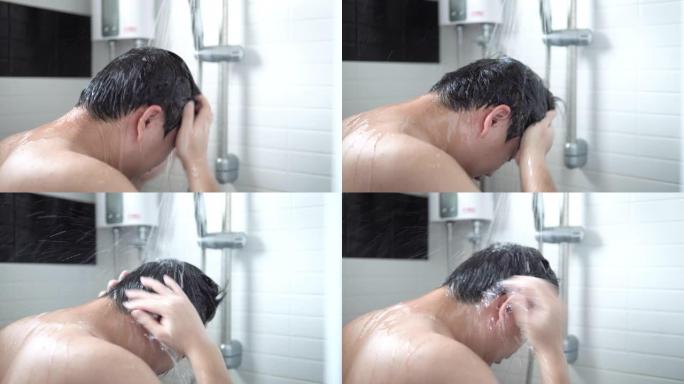 亚洲男人正在浴室里洗头发和沐浴露。