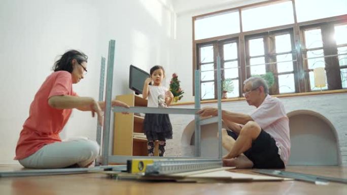 亚洲家庭老人为孩子准备和安装架子