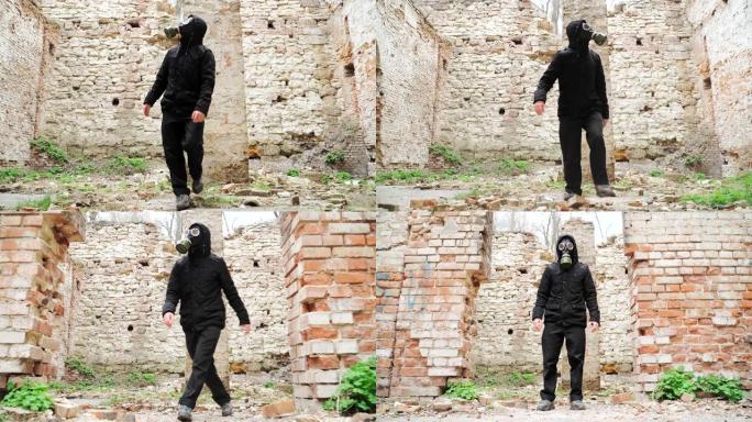 戴着防毒面具和黑色衣服的人是这座废弃建筑的废墟之一。跟踪者概念，核化学战争后的幸存者。慢动作。在St