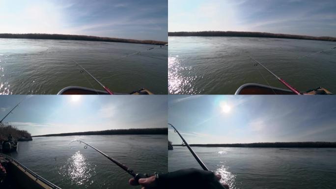在晴朗的天气里，渔夫在美丽的河上的旋转竿上钓鱼