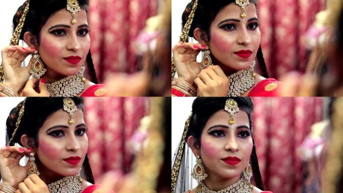 美丽的年轻印度新娘照镜子