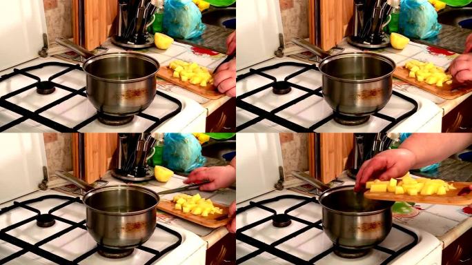 厨房里的一个女人用刀准备食物切土豆和胡萝卜