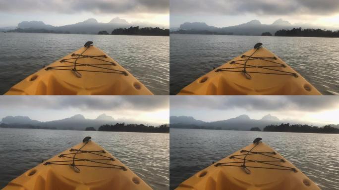 在太阳e time.ca概念的山景湖中划独木舟时的视点
