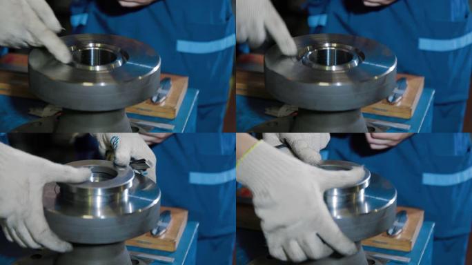 工业公司的工人检查井口配件和蝶阀的质量零件。工厂零件在生产过程中使用前的质量控制