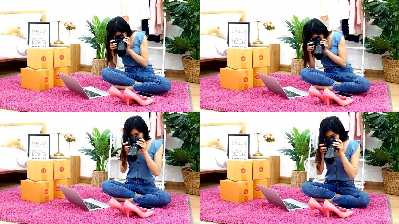 4K.亚洲妇女在家里的卧室通过手机在网站上拍摄鞋子，时尚配饰的照片，以便上传和在线销售。自助隔离期间