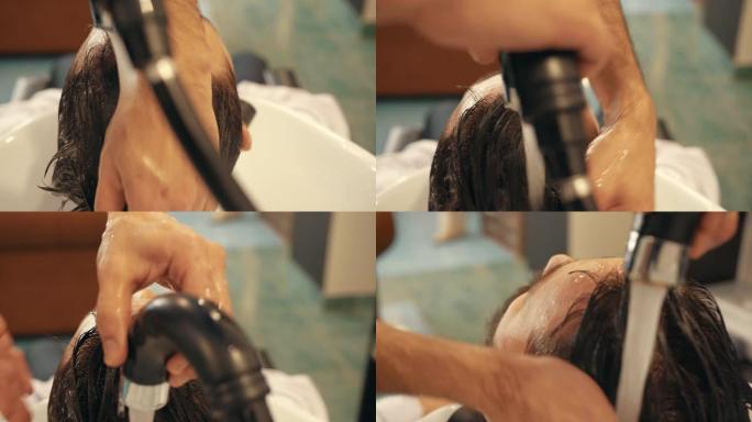 理发师给男客户洗头的特写镜头