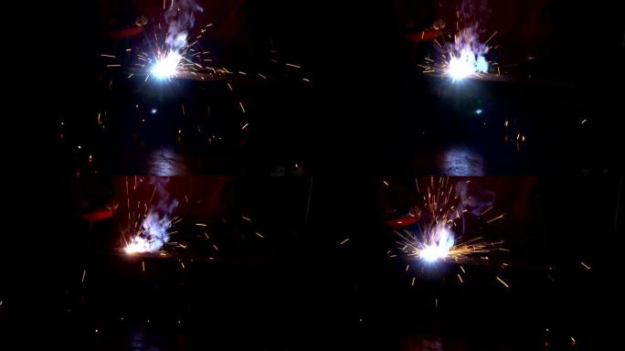 在弱光下使用焊接机的焊机特写。