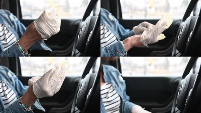 女人独自戴着手套坐在汽车驾驶座上