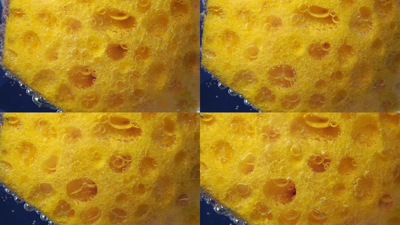 洗碗海绵纹理背景。用于洗碗的黄色海绵表面。水下特写