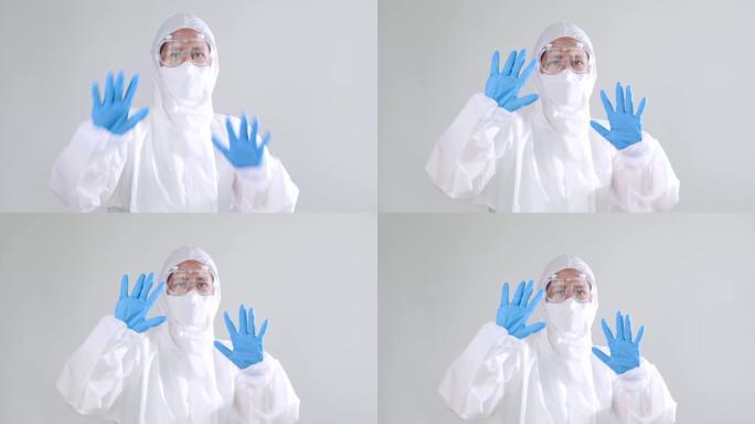 穿着PPE套装的慢动作亚洲医生显示手势不或停止