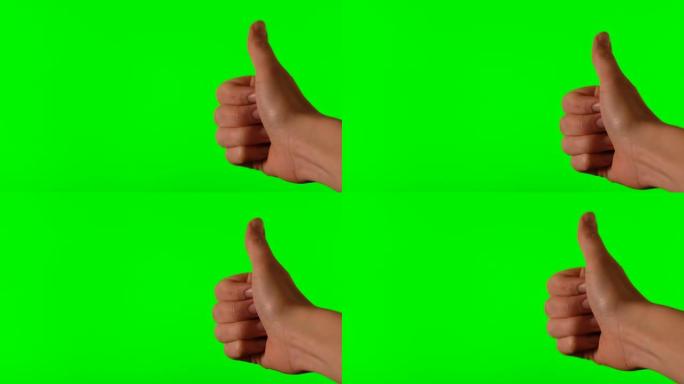 在绿色背景上竖起大拇指的手