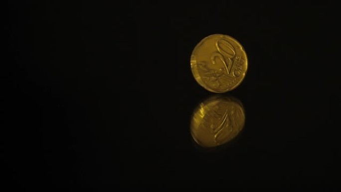 20欧分硬币在黑色镜子上旋转
