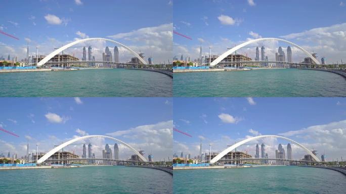 公差桥。湖泊或河流的建筑结构，迪拜市中心的天际线，阿拉伯联合酋长国或阿联酋。蓝天背景的城市金融区和商
