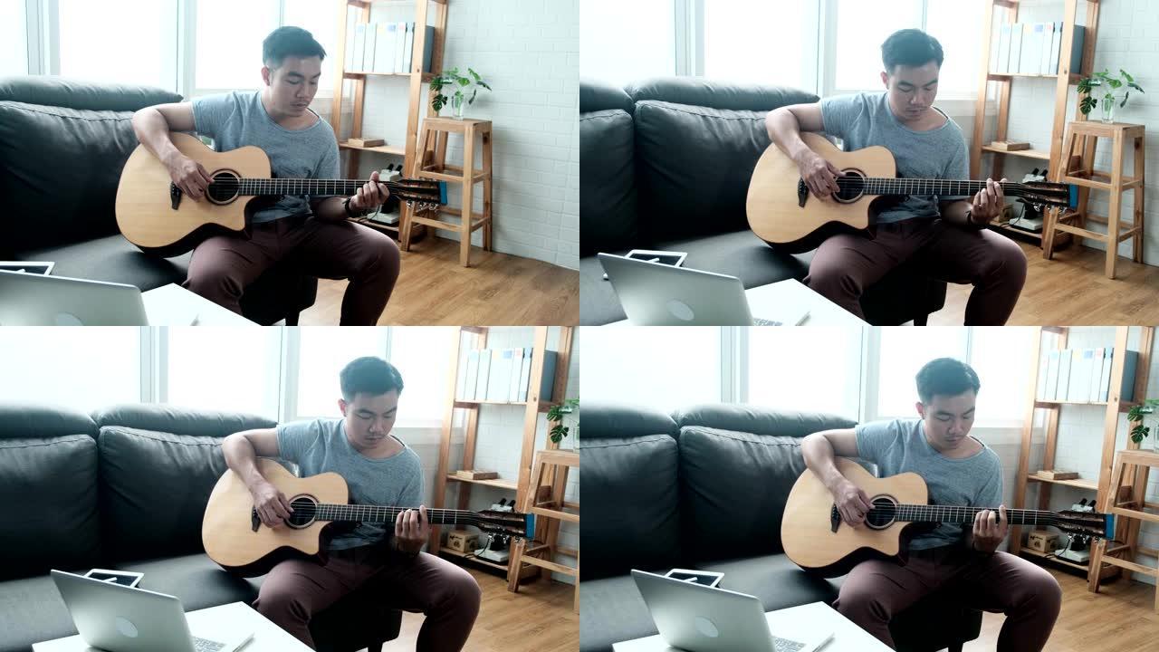 音乐家亚洲男性演奏原声吉他乐器唱歌学习练习无忧无虑的时间花活动职业坐在客厅沙发上