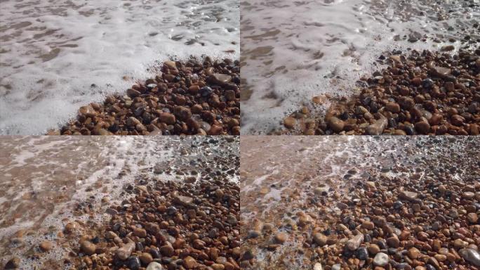 英格兰卵石布赖顿海滩上的海浪慢动作缩小