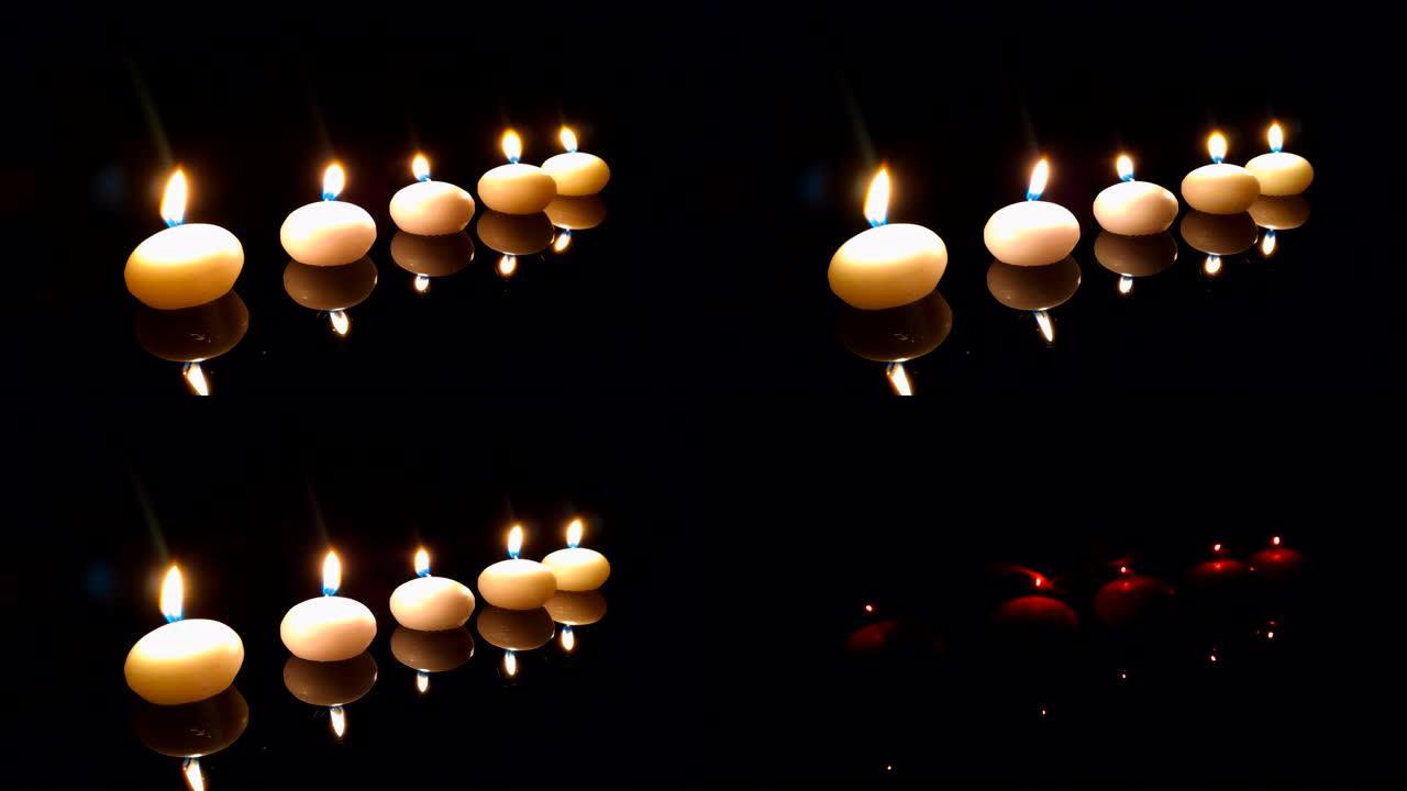 一排蜡烛在黑暗中点燃