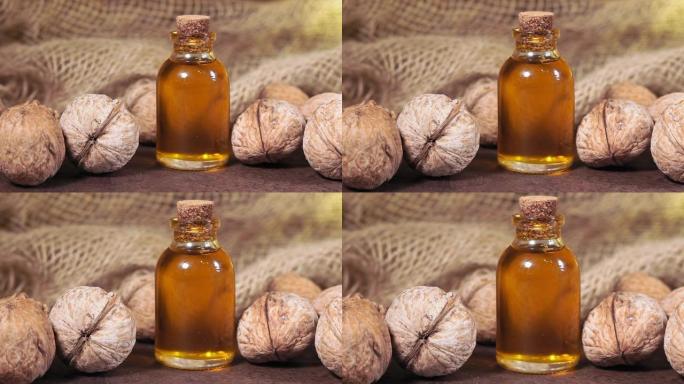 天然血清。澳大利亚坚果，杏仁，核桃，松子的化妆品和药油在棕色背景。