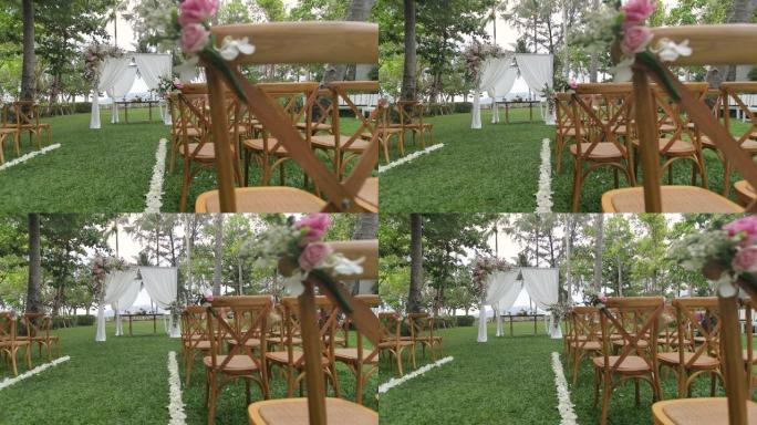 户外用布和鲜花装饰的婚礼拱门。