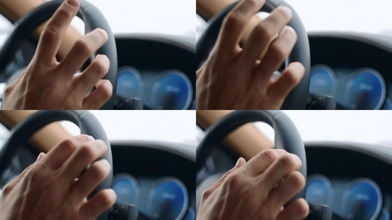 男性手敲方向盘上的手指。男子将手指放在车轮上
