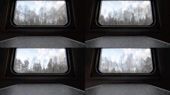 行驶中的旅客列车的窗户视图。