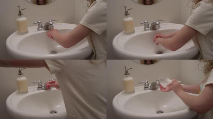 女孩完成洗手并用一次性纸巾擦干