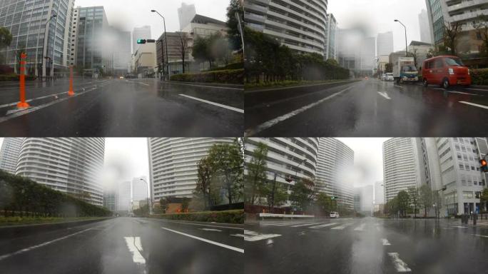 驾车穿越多雨的城市/后视图