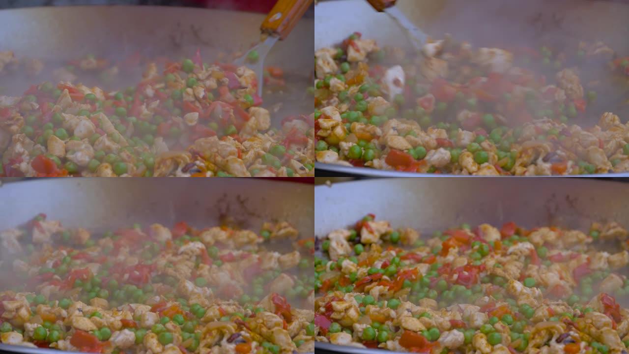 特写镜头: 厨师在巨大的炒锅中烹饪肉块，辣椒，豌豆-慢动作