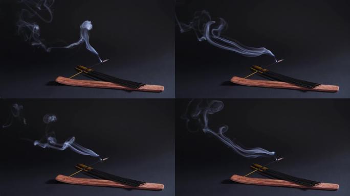 治疗东方烟雾。芳香疗法、放松和瑜伽。香气棒中的烟雾在黑色背景4k上移动
