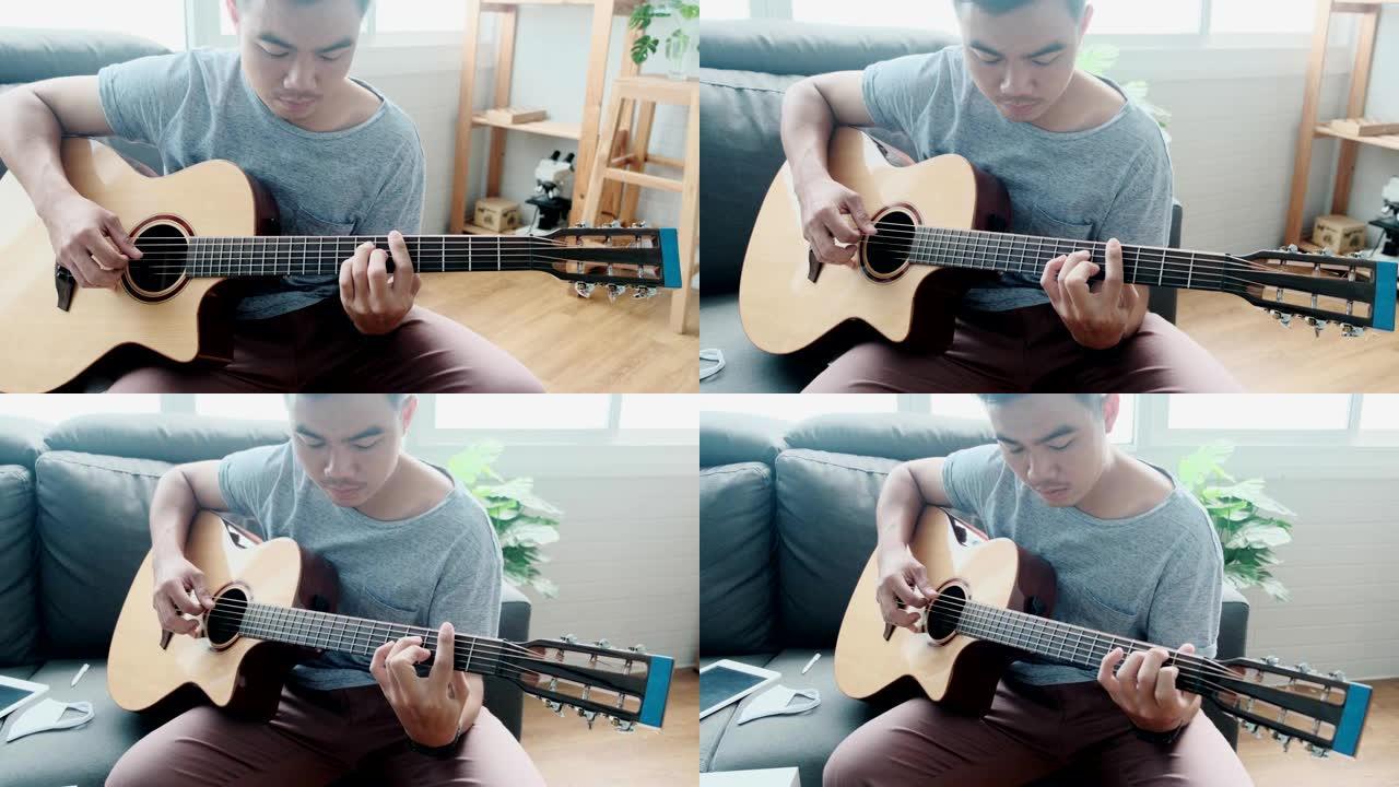 音乐家亚洲男性演奏原声吉他乐器唱歌学习练习无忧无虑的时间花活动职业坐在客厅沙发上
