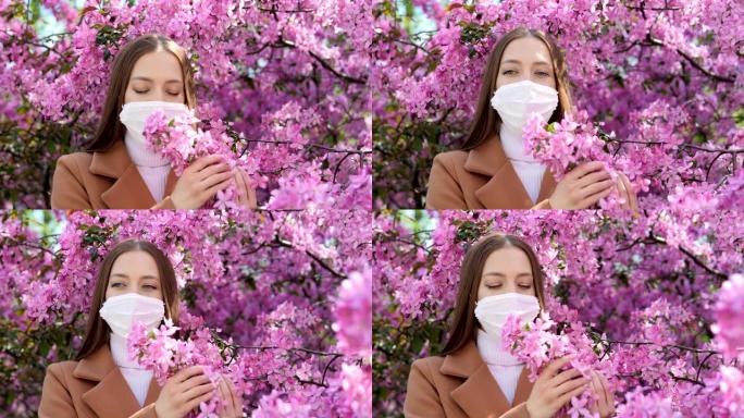 一个戴着医用口罩的女孩站在一棵开花的树附近。冠状病毒流行病。新型冠状病毒肺炎