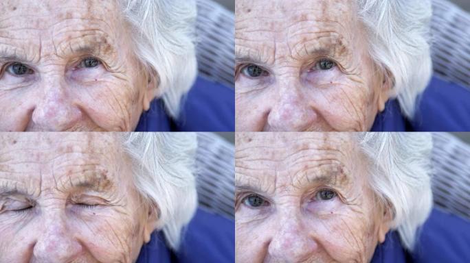 美丽，敏锐，聪明的老年高加索妇女独特的斑点漂亮的眼睛和脸在夏天的户外