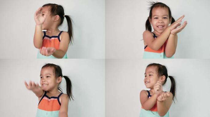快乐的亚洲儿童女孩的肖像喜欢跳舞，并在白色背景上演唱歌曲 “小鲨鱼”。幸福家庭和童年的概念。