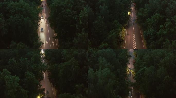 穿越城市公园区的夜间道路的无人机视频