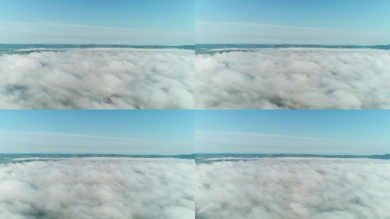 4k延时低角度视角云景，风吹着白色蓬松的云，在晴朗的天空中通过太阳，阳光穿过云。