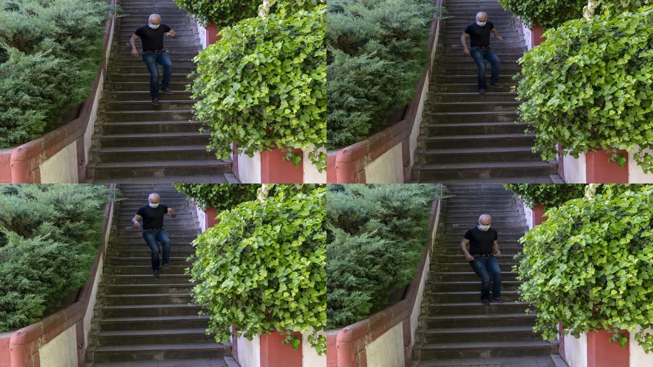 时间流逝-活跃的高级男子在宵禁自由日在公园的楼梯上戴着面具跳跃，在冠状病毒时期的宵禁中安卡拉
