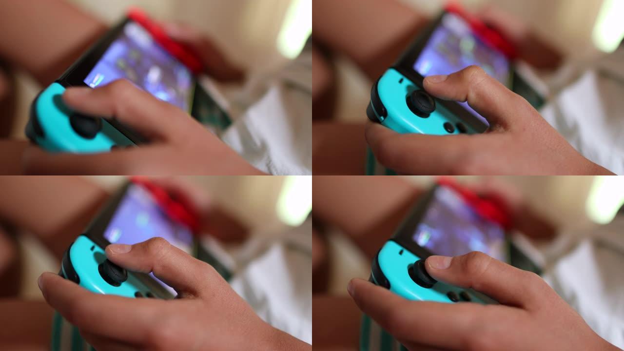 儿童手在设备上近距离玩游戏。操纵杆上的孩子手指