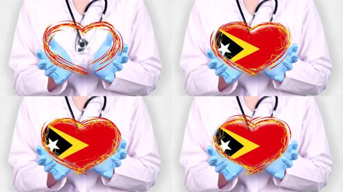 特写。医生穿着医用白大褂，蓝色手套握在手中，用东帝汶国旗画出跳动的心。医生与全球流行病作斗争的概念，