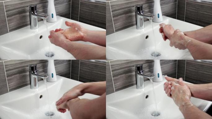 男人用肥皂和热水洗手