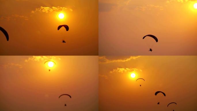日落天空背景上的剪影滑翔伞