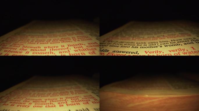 极端微距特写移动滑块拍摄的圣经突出耶稣的话约翰福音3:16在基督教圣经国王詹姆斯翻译与红色字母的话语